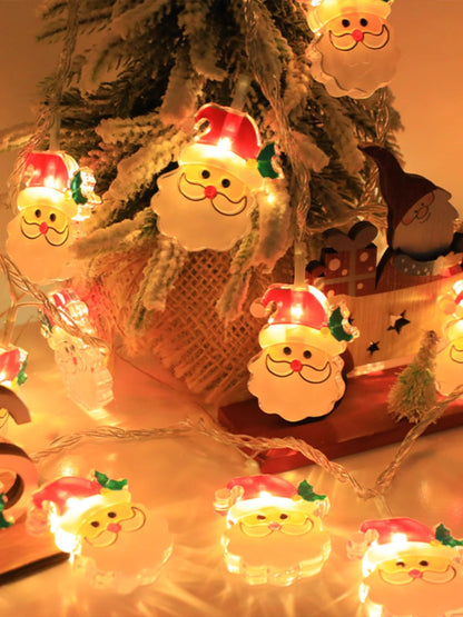 Santa Claus-shaped lights on a Christmas tree with warm glow