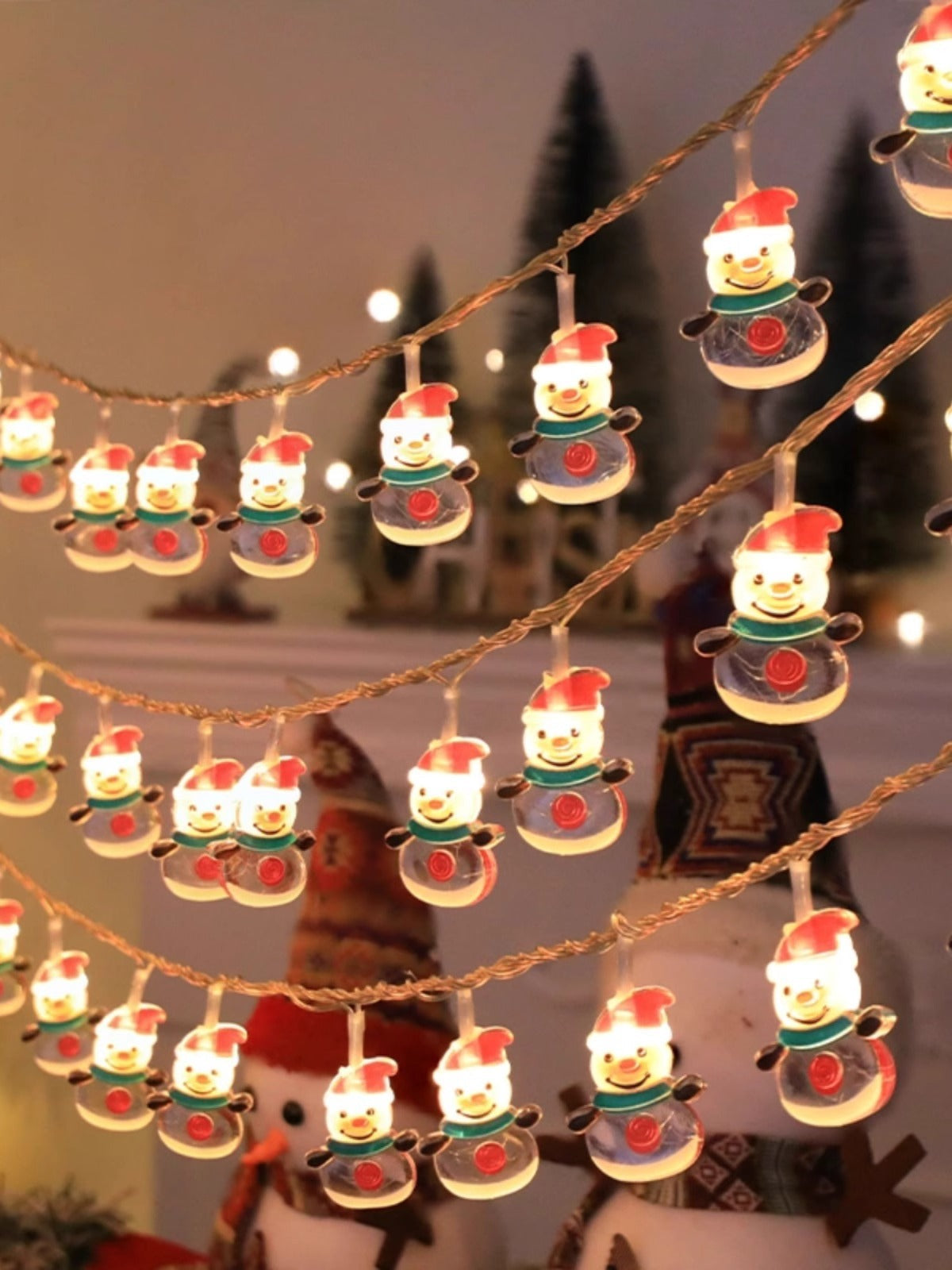 String lights with snowman design hanging against a festive background