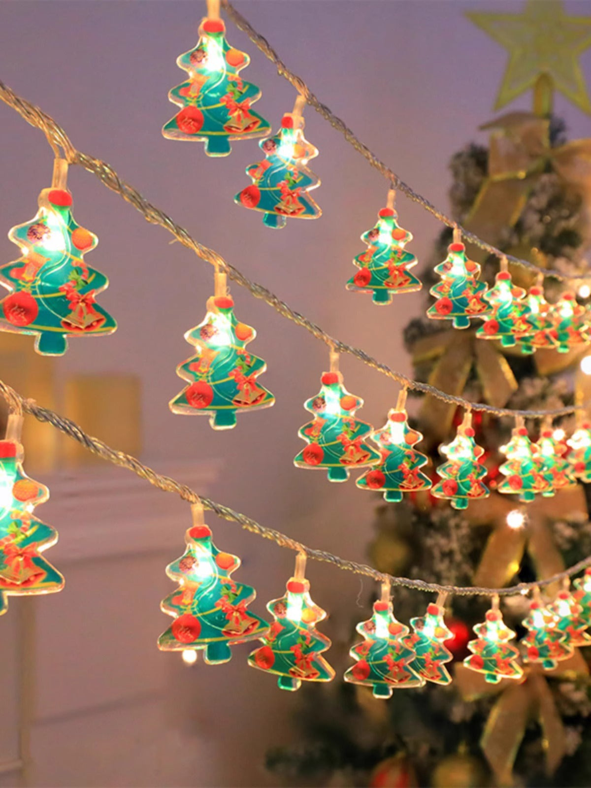 String lights shaped like Christmas trees with a blurred background