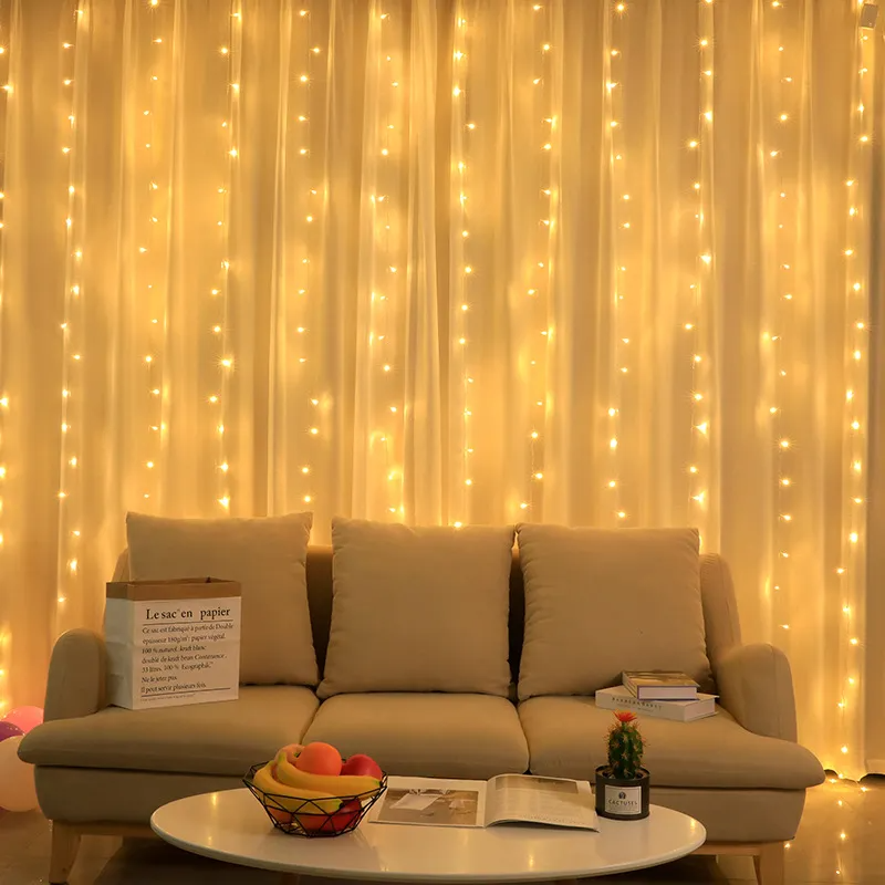 Beige sofa with a coffee table in front of a LED Curtain Fairy Lights