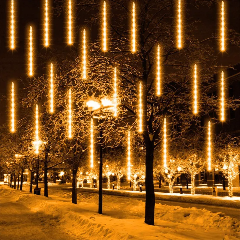 Street scene with snow-covered trees and LED Meteor Shower Lights Outdoor at night.