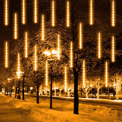 Street scene with snow-covered trees and LED Meteor Shower Lights Outdoor at night.