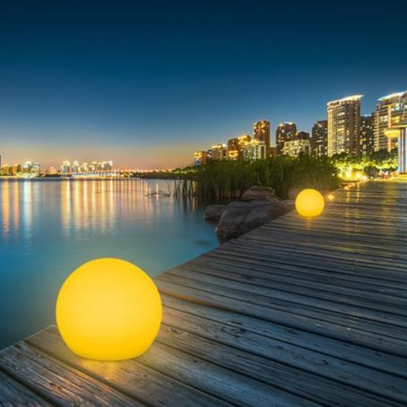 Modern LED Orb Lights Outdoor on a wooden dock with city skyline in the background
