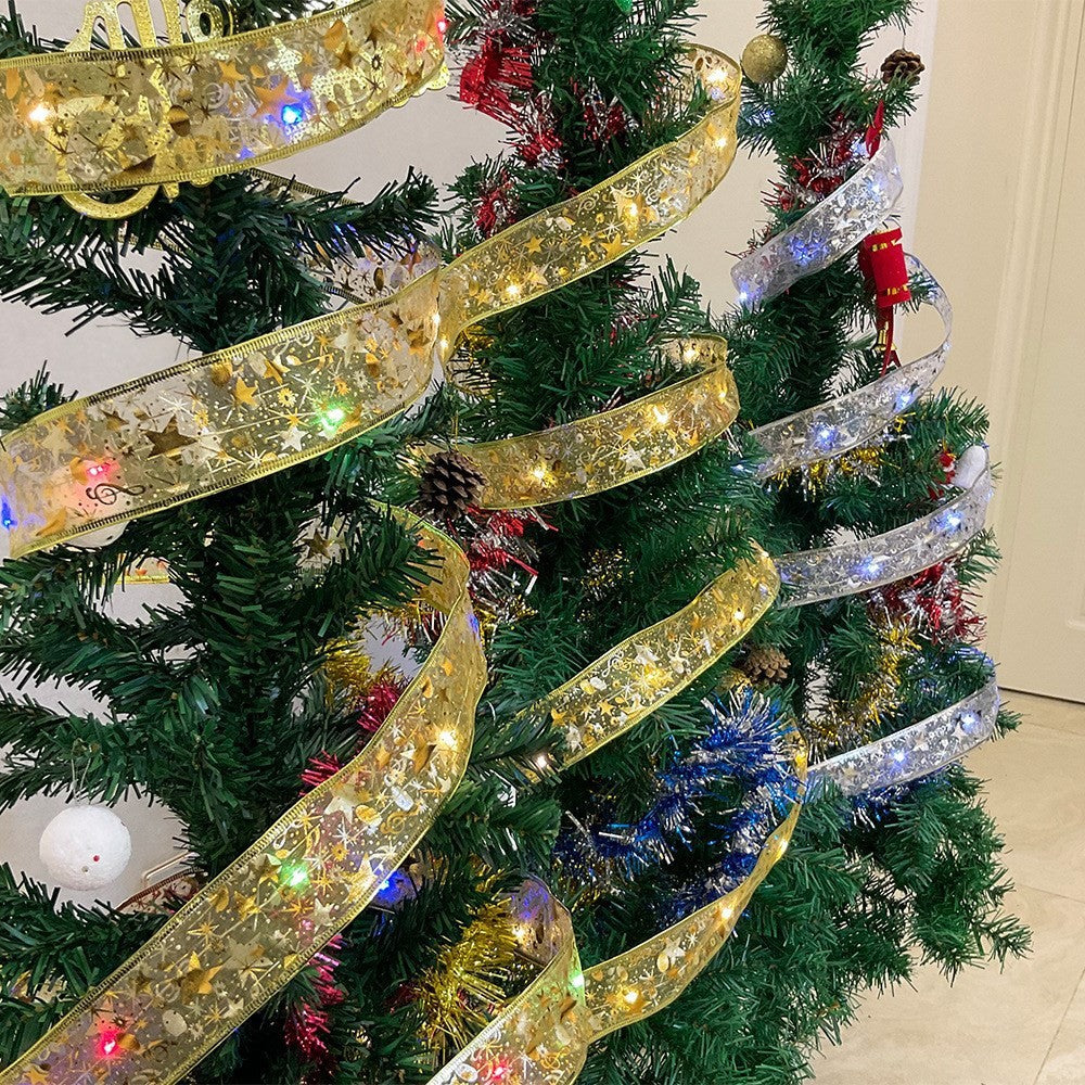 Decorated Christmas tree with gold and silver ribbon lights