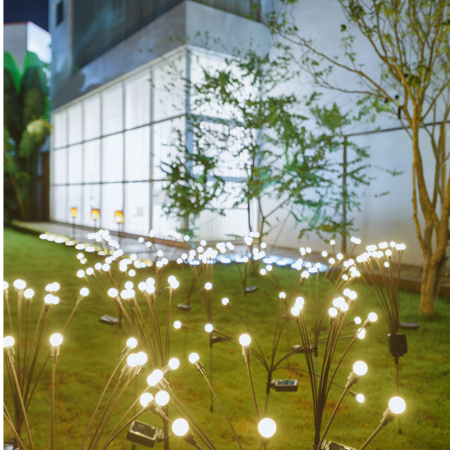 Solar Firework Garden Lights on grass in front of a building