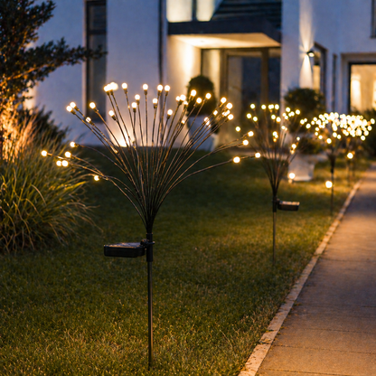 Solar Firework Garden Lights on grass with a house in the background