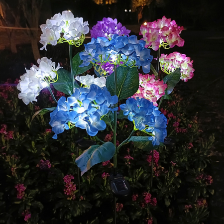 Solar Hydrangea Garden Lights with lights on a dark background