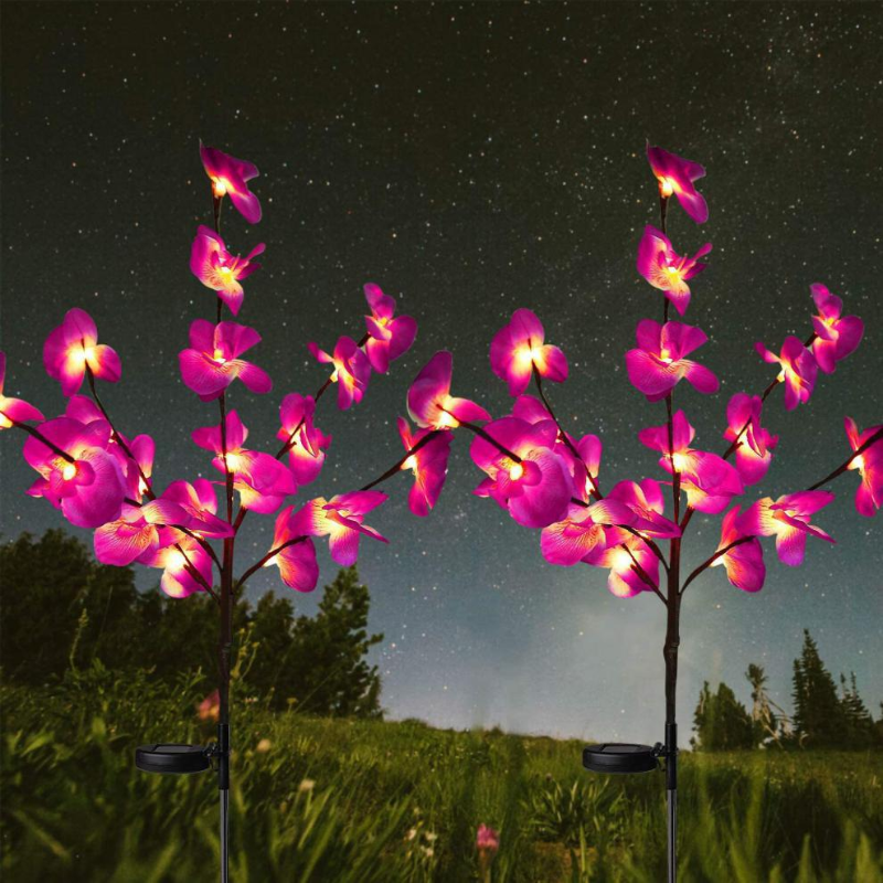 Solar Orchid Garden Lights on stakes against a night sky with stars.