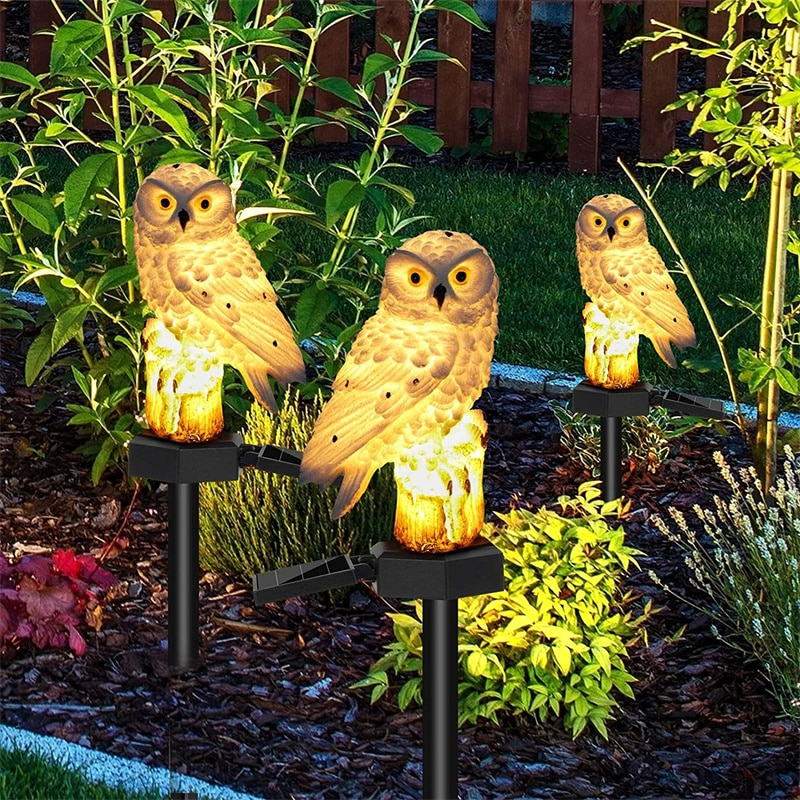 Three Solar Owl Garden Lights Outdoor in a garden setting.