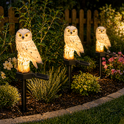 Solar Owl Garden Lights Outdoor in a garden setting with plants and flowers.
