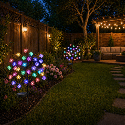 Garden with Solar Powered Flower Garden Lights and a wooden fence in the background.