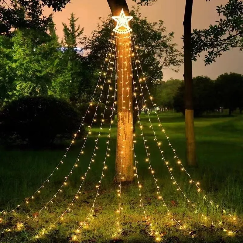 Solar Star Curtain Lights Outdoor draped over a tree in a garden setting with a star-shaped light on top.