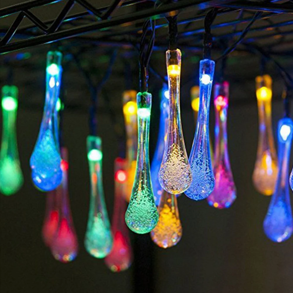 String of colorful Solar Water Drop Fairy Lights hanging from a structure.