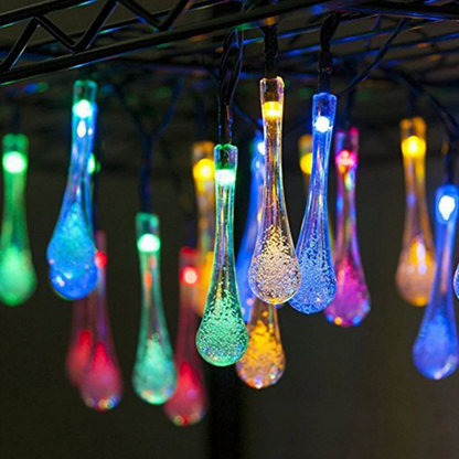 String of colorful Solar Water Drop Fairy Lights hanging from a structure.