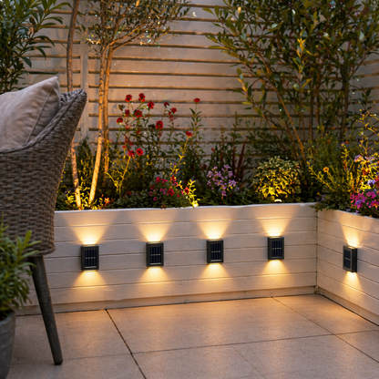 Up & Down LED Garden Lights in Outdoor patio with garden lights, plants, and a chair.