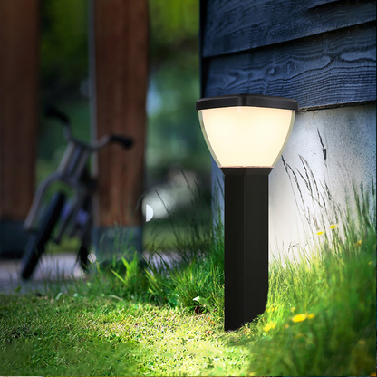 Waterproof Outdoor Solar LED Pillar Light illuminating a grassy area with a bicycle in the background