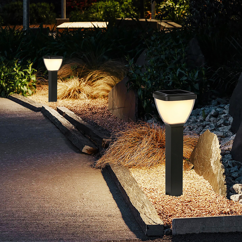 Waterproof Outdoor Solar LED Pillar Light illuminating a pathway in a garden setting.