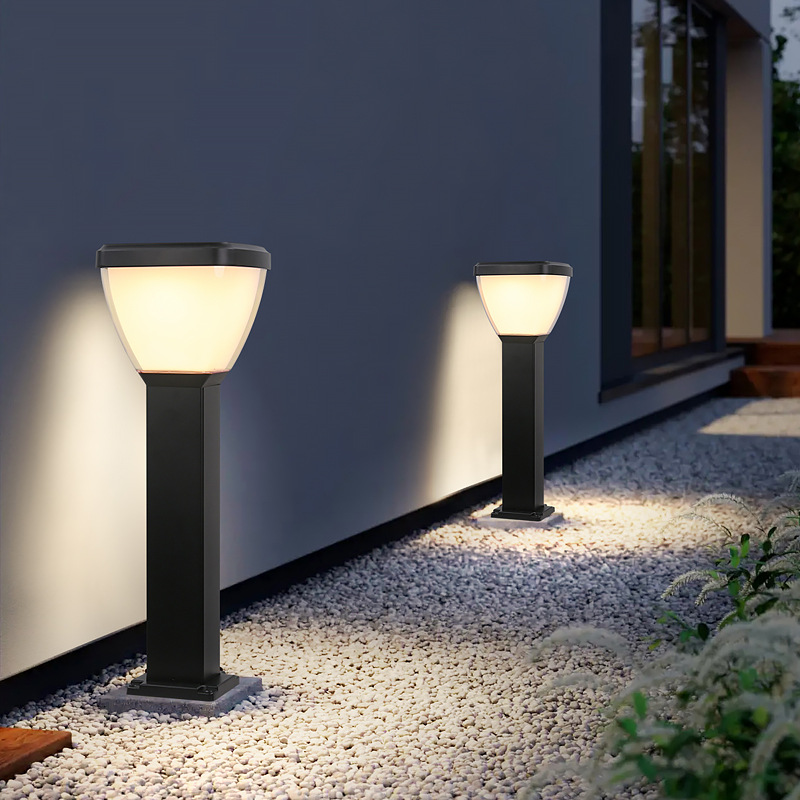 Two Waterproof Outdoor Solar LED Pillar Light on a pebble path next to a building.