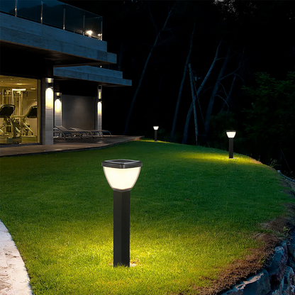 Waterproof Outdoor Solar LED Pillar Light illuminating a grassy area outside a modern house at night.