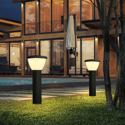 Two Waterproof Outdoor Solar LED Pillar Light illuminated in front of a modern house with a pool.